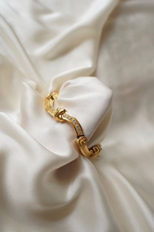 Gianni Versace Greek Key and Crystal Bracelet — Bracelet arranged on ivory satin