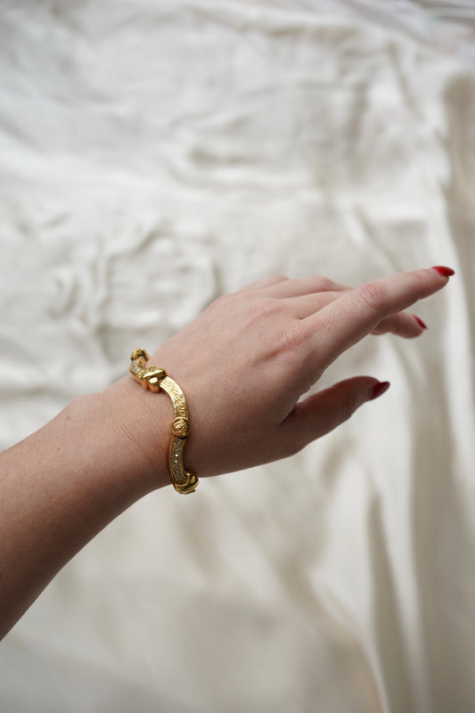 Gianni Versace Greek Key and Crystal Bracelet — Gold bracelet worn on a wrist