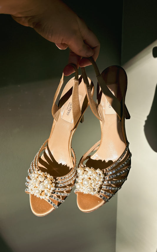 Valentino Garavani Beige Pearl & Crystal Slingback Heels (39) — Front view of the pair held by their straps