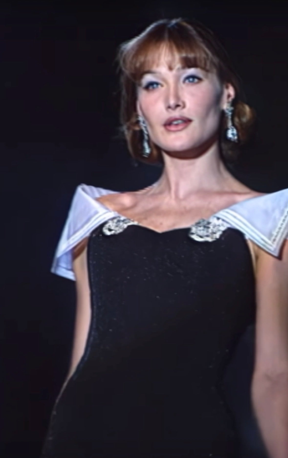 Christian Dior Boutique FW 1995 Runway Black Embellished Evening Gown — Runway reference showing the black gown with draped shoulder fabric